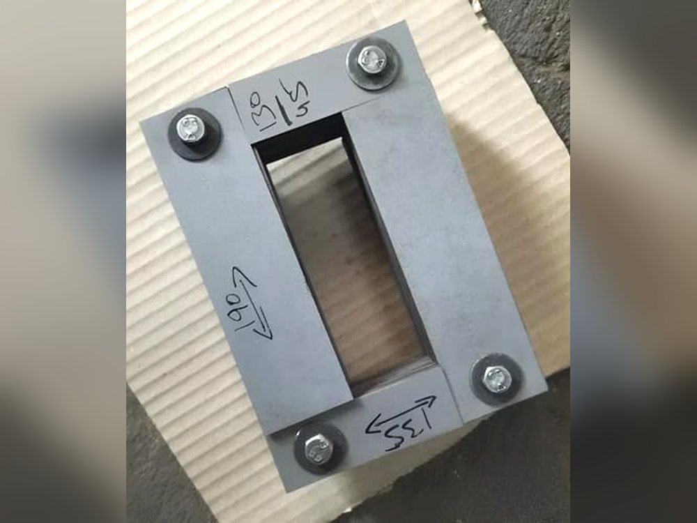 Assembled and clamped single phase transformer core built from stacked laminations